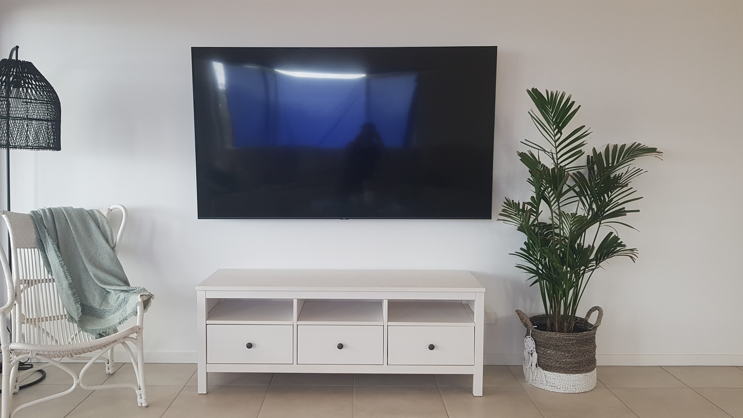 Television wall mounted above a console with the cabling concealed